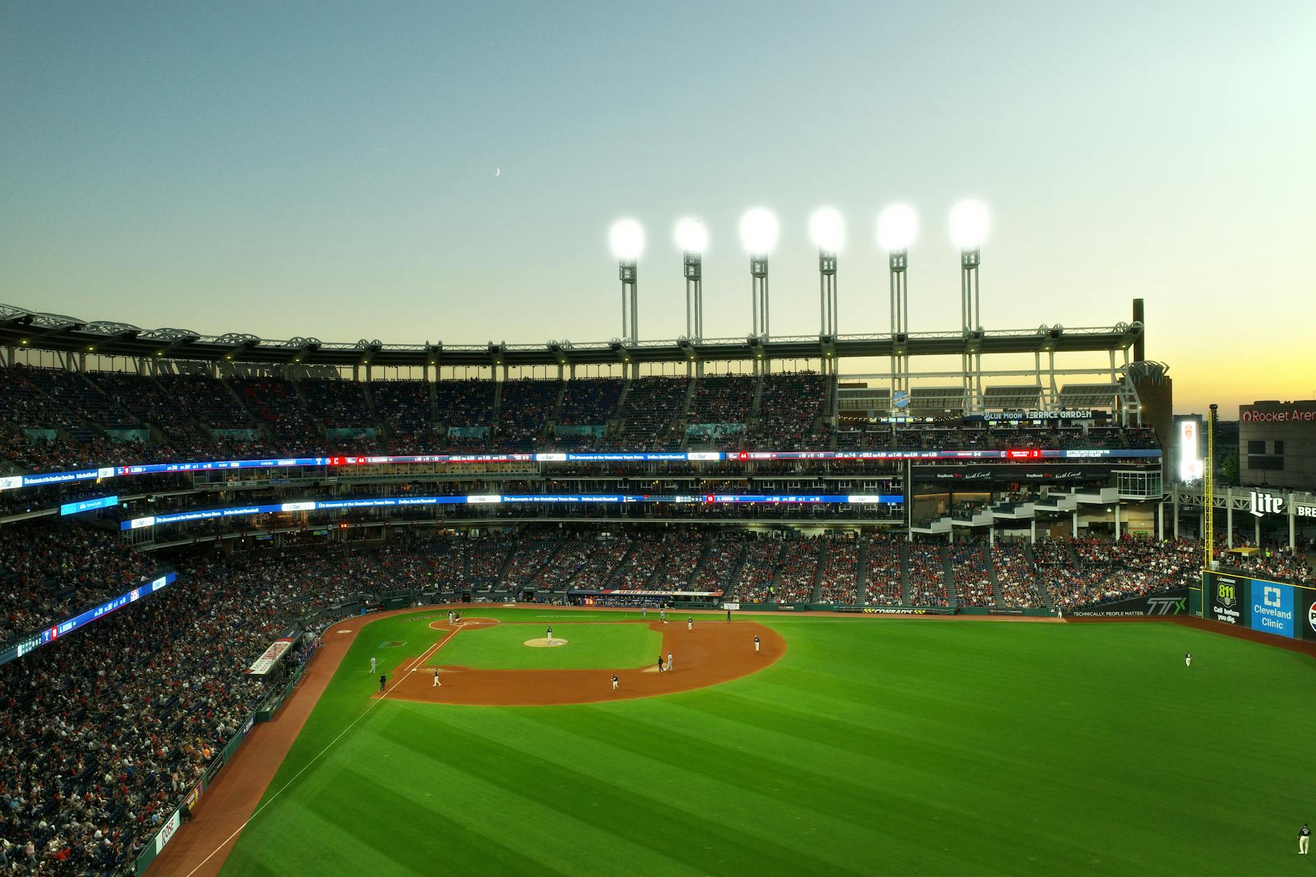 A vibrant twilight baseball game at Cleveland's Progressive Field, capturing the lively atmosphere.