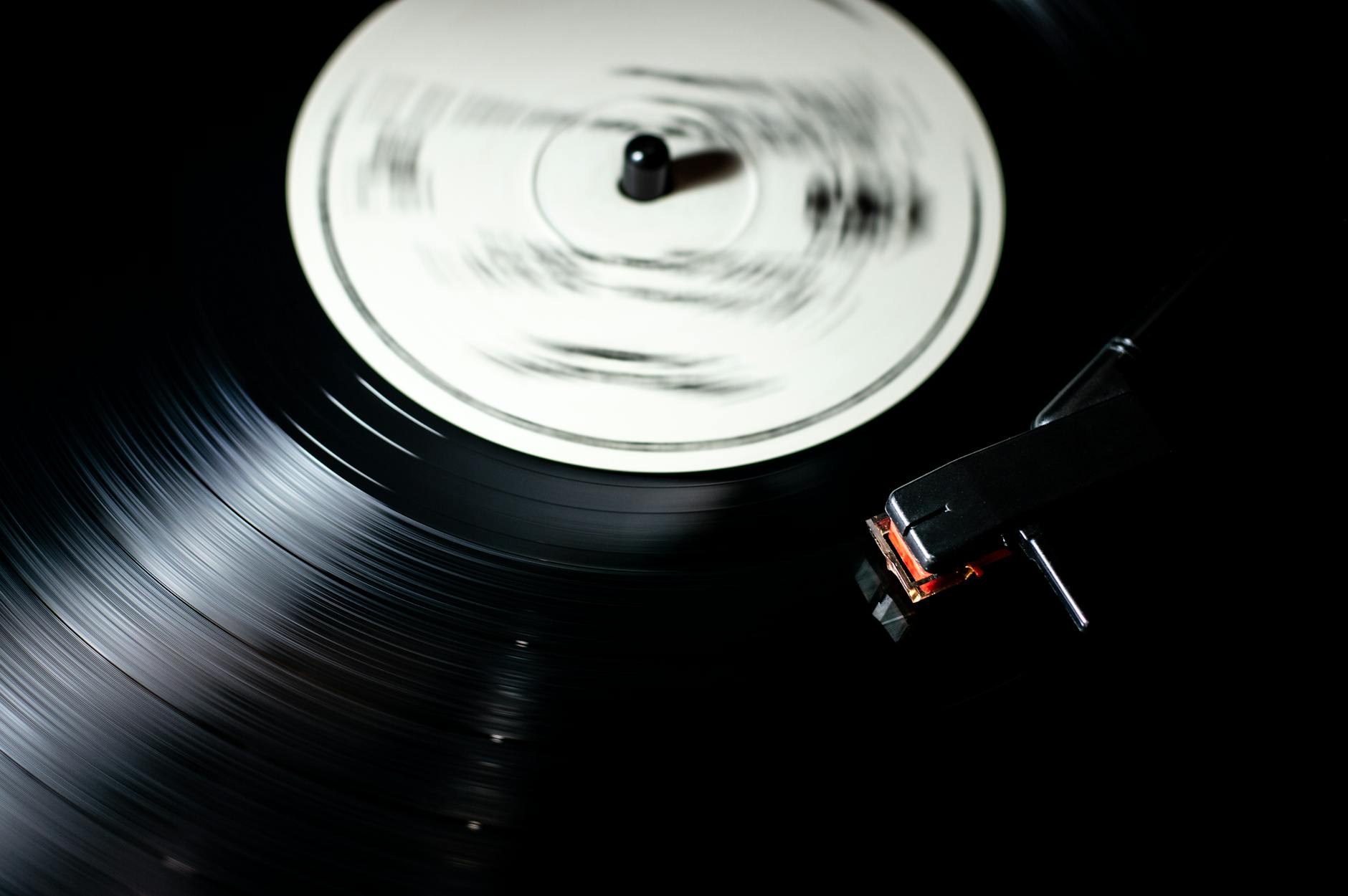 Close-up of a vintage vinyl record spinning on a turntable.