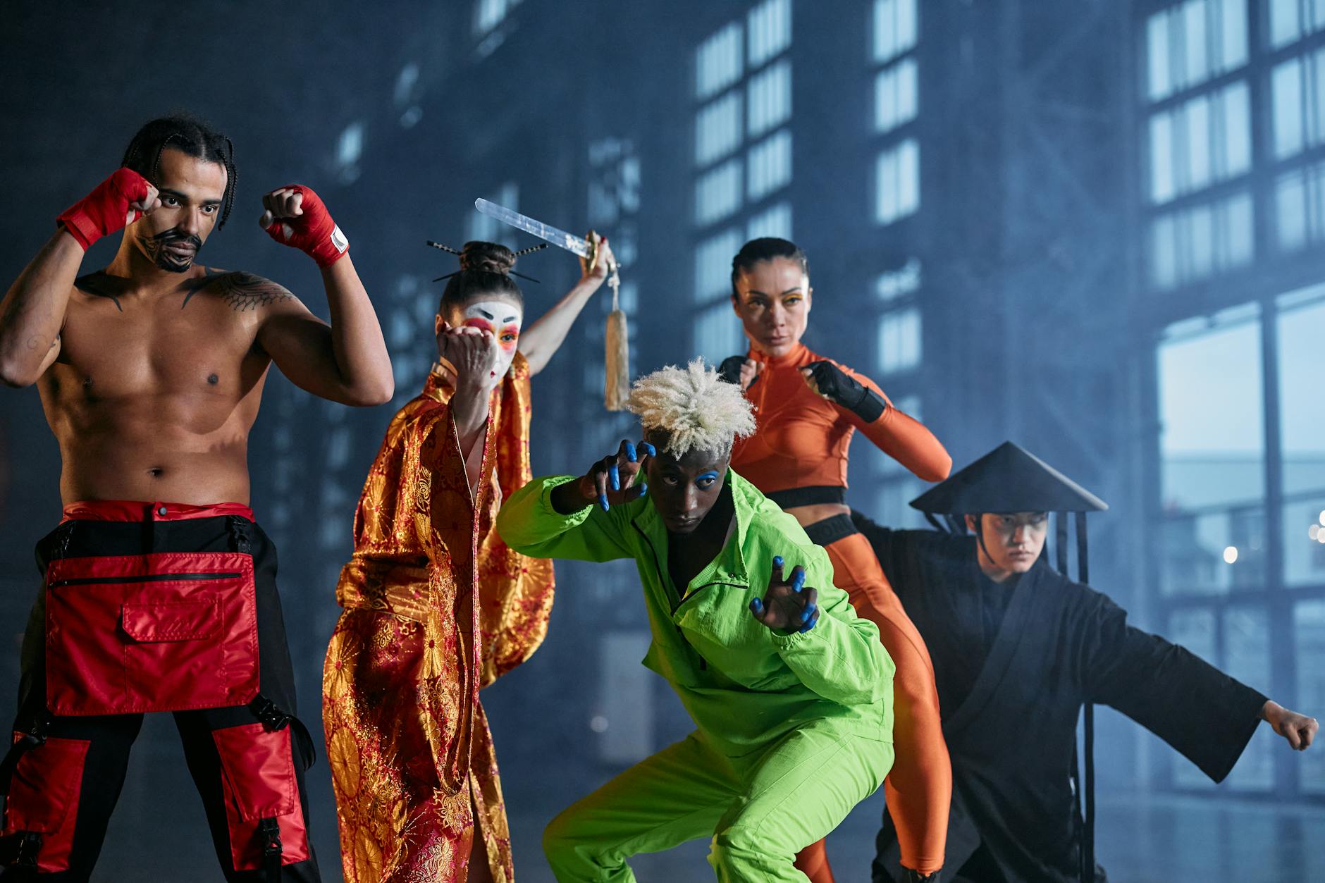 A group of diverse cosplayers striking dynamic poses indoors, showcasing various character styles.