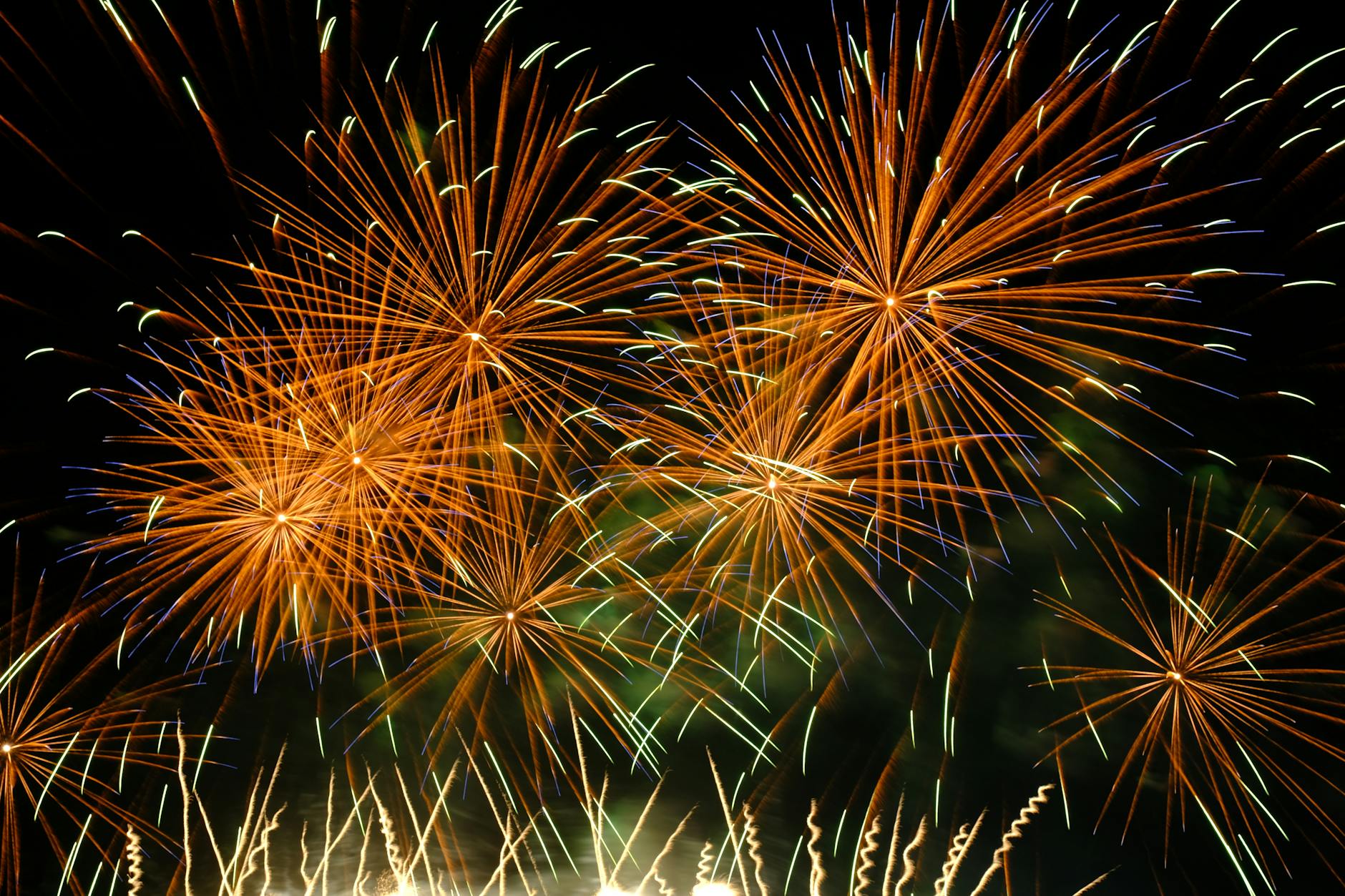 Colorful fireworks exploding against a dark night sky creating a dazzling spectacle.