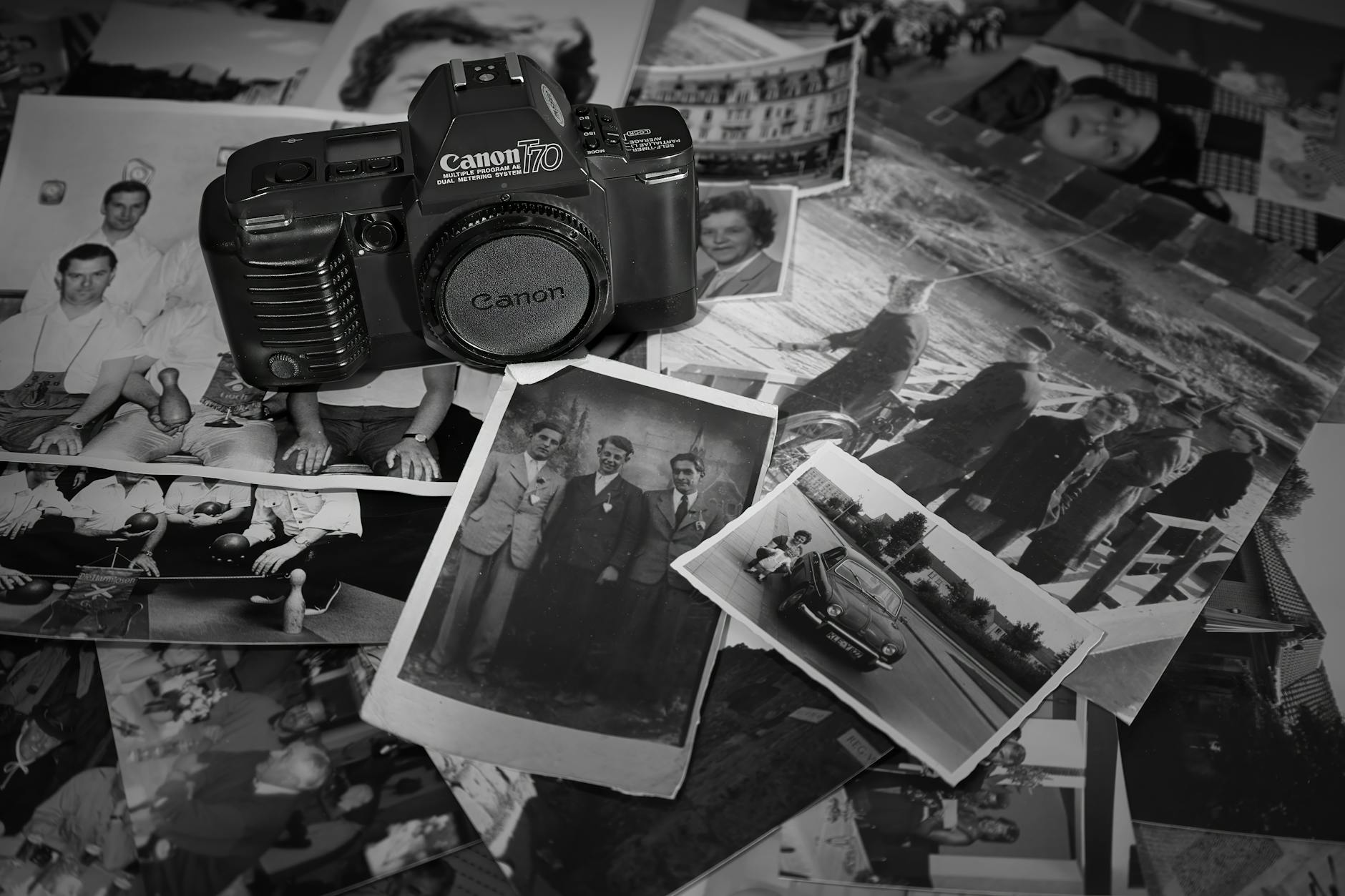 A nostalgic display of a vintage camera surrounded by black and white photographs showcasing memories.