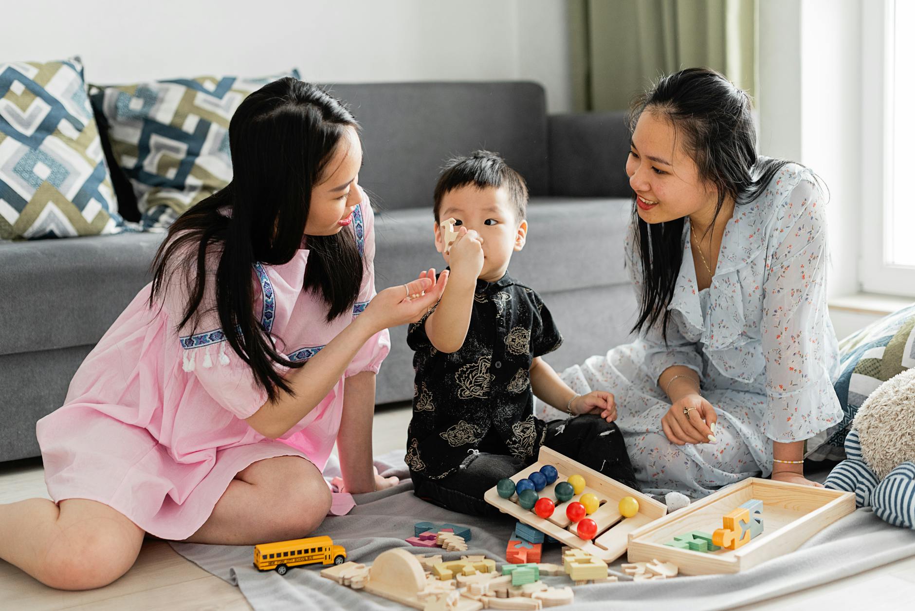 A loving family interaction with wooden toys, showcasing mother and child bonding indoors.
